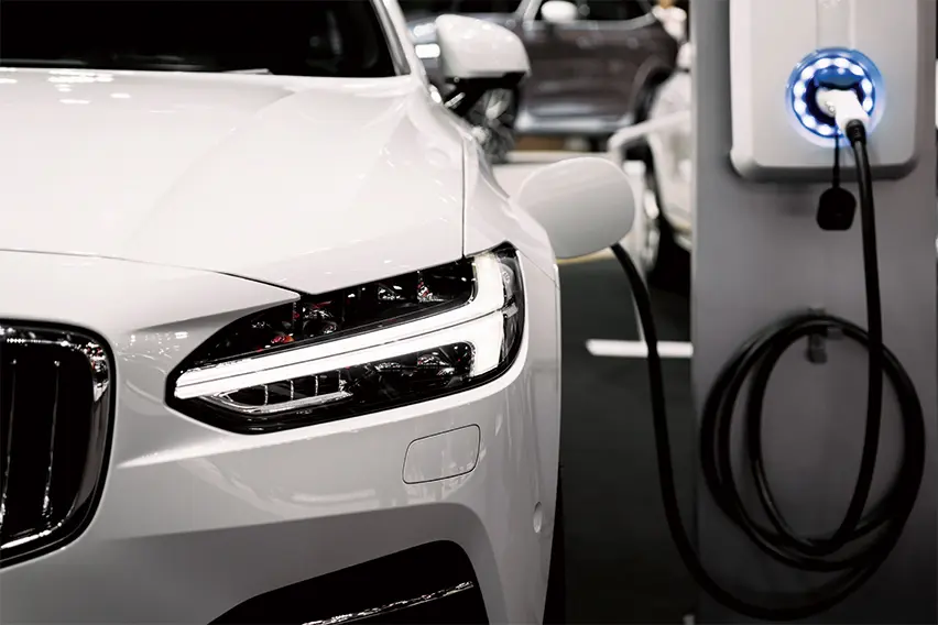 white-EV-automobile-is-charging-in-the-parking-lot