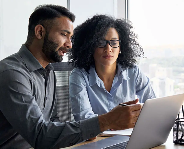 Team of businesspeople smiling at the camera in a boardroom office