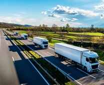 White Trucks with containers on highway