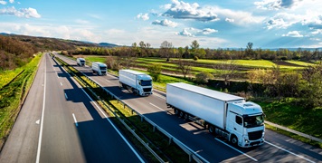 White Trucks with containers on highway