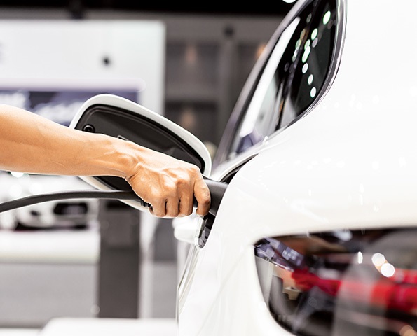 a-hand-is-holding-ev-charging-pump a-hand-is-holding-ev-charging-pump