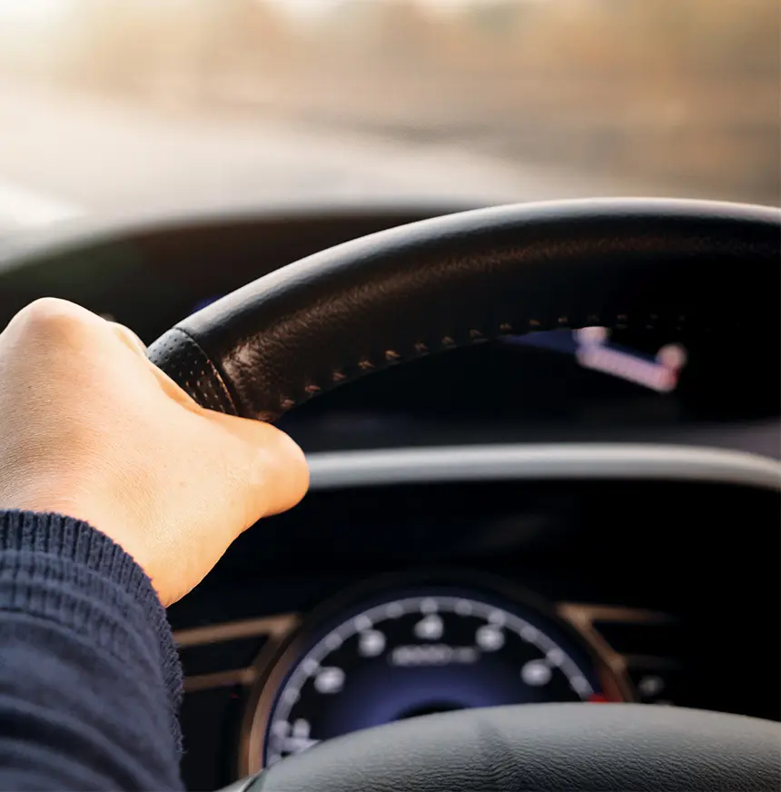 Close-Up-Mans-Hand-Driving-A-Car