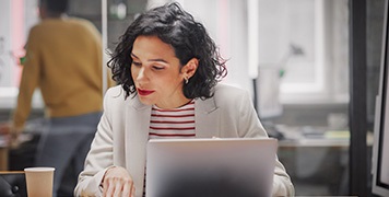 Busy-Professional-Woman-Checking-Documents-And-Her-Laptop