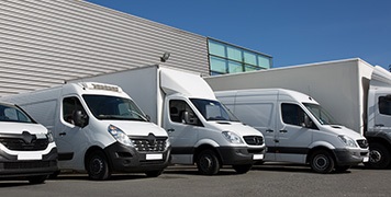 multiple-vans-and-cars-parked-in-parking-lot