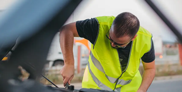 Man-repairing-car-on-road