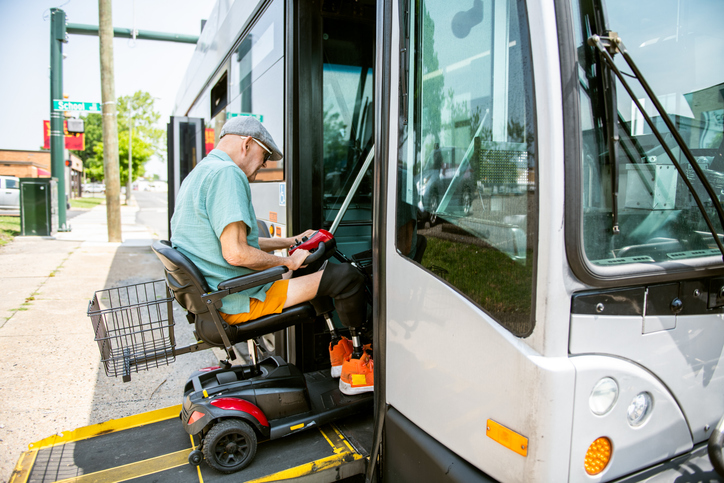 Disabled senior man accessing community bus