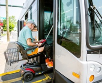 Disabled senior man accessing community bus
