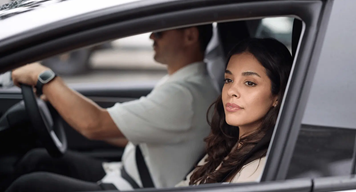 Two people driving in a vehicle