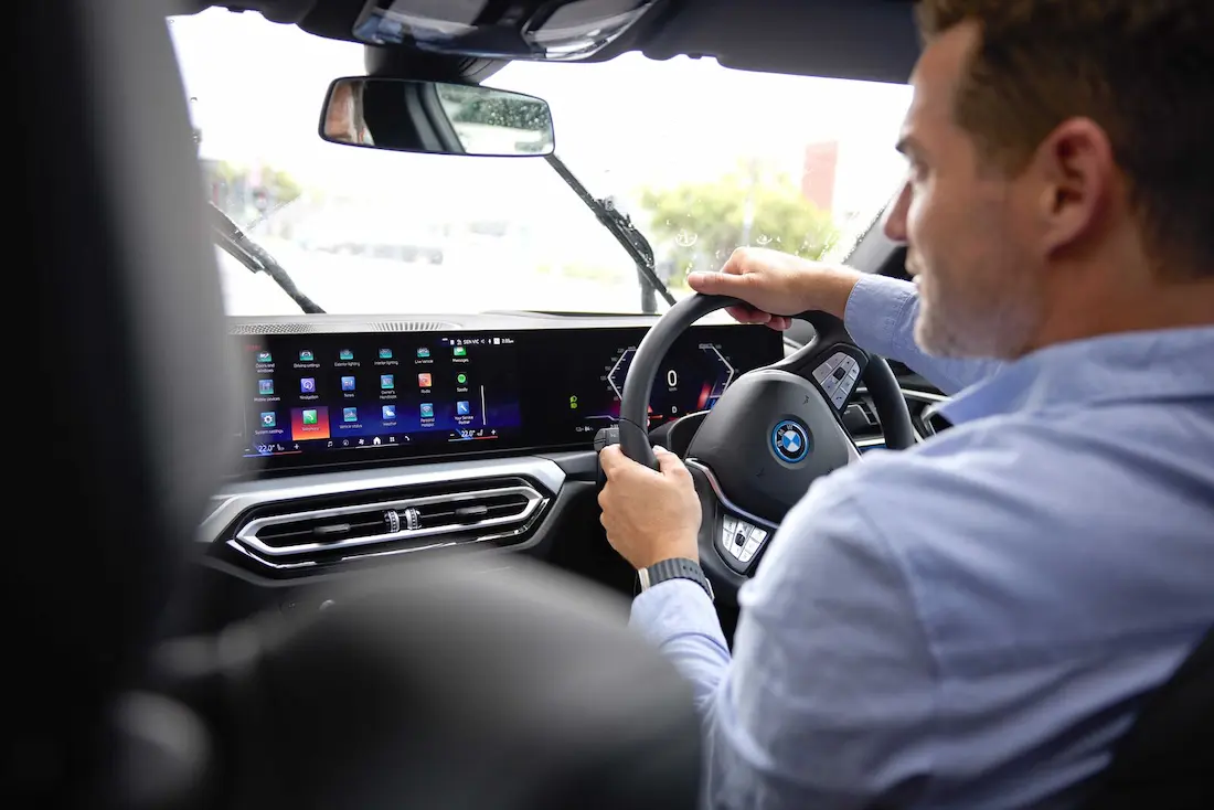 Person driving vehicle as seen from the back seat
