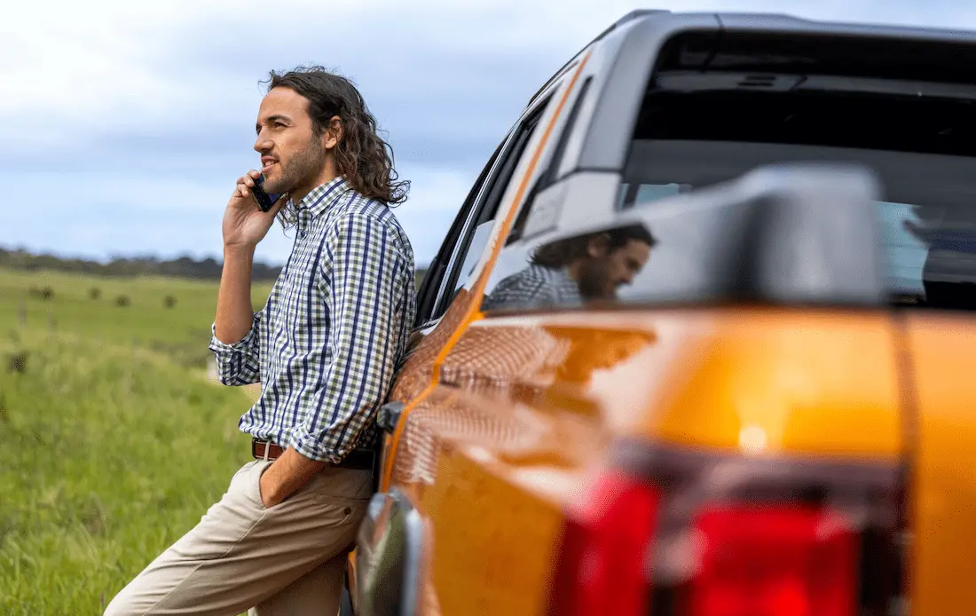 man standing next to ute