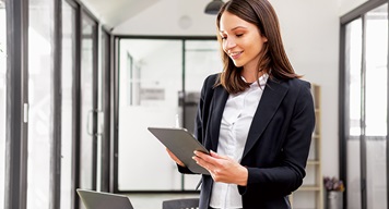 Corporate woman working on tablet