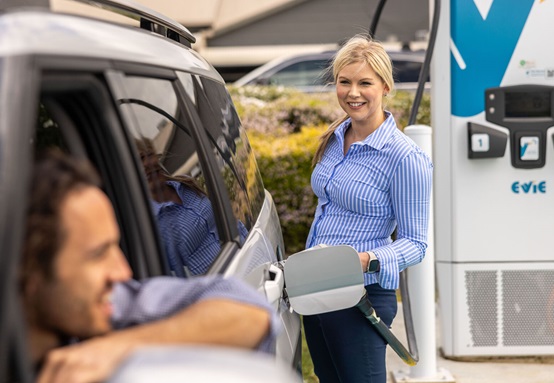 Woman charging an EV