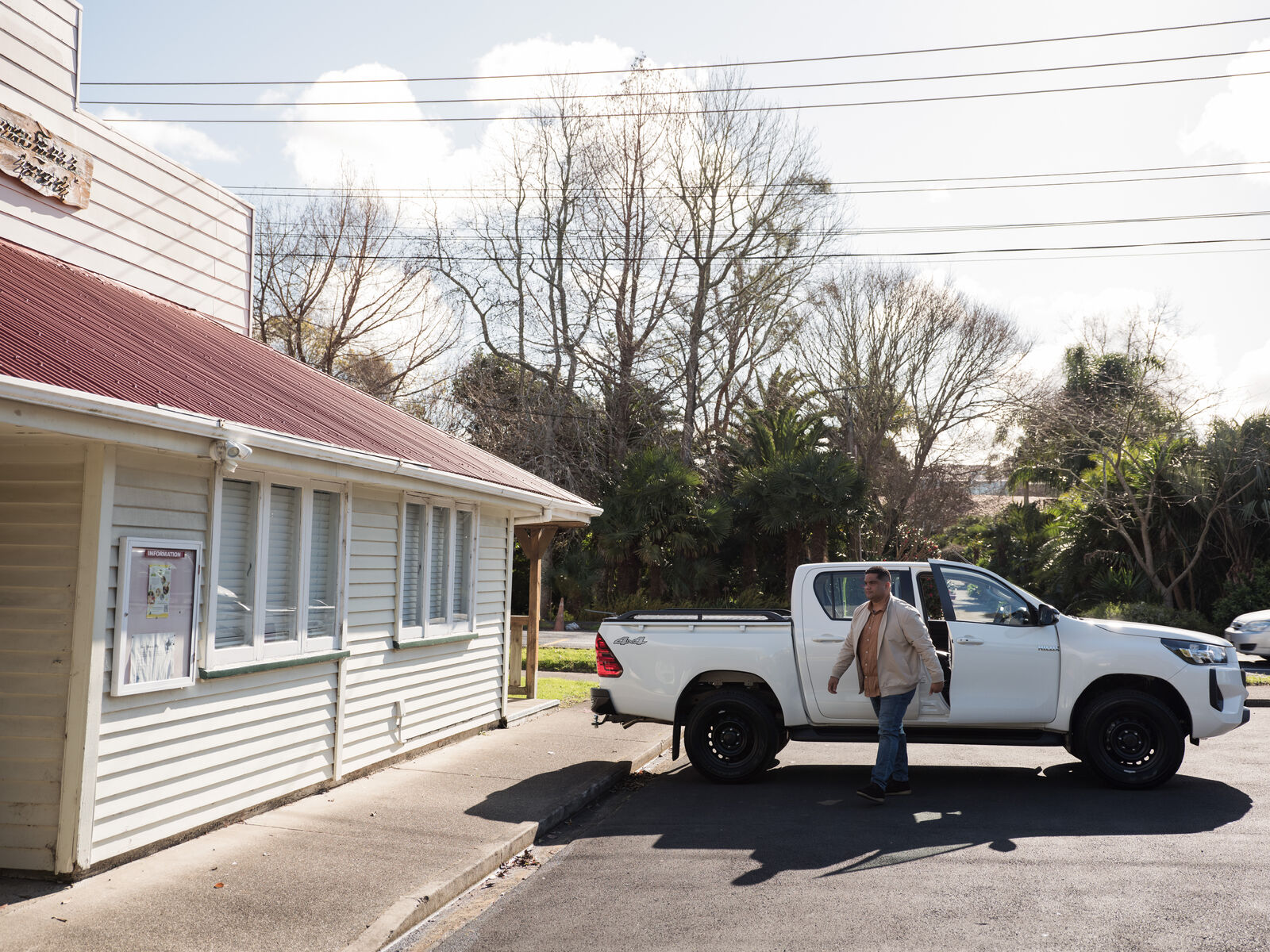 Man leaving a parked car to go into a house