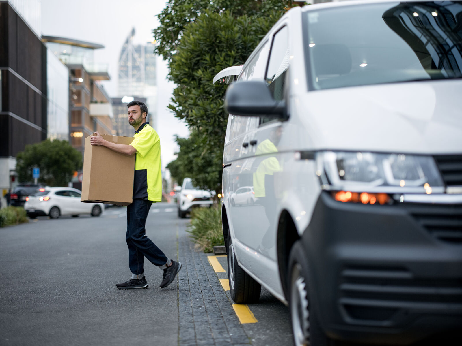 Courier driver delivering a box in Auckland