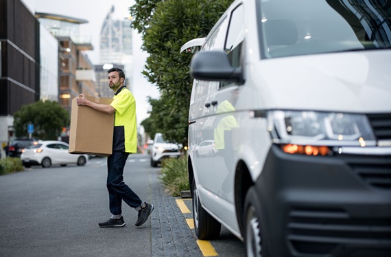Courier driver delivering a box in Auckland