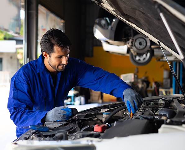 car-mechanic-checking-the-oil-level-of-the-car-engine car-mechanic-checking-the-oil-level-of-the-car-engine