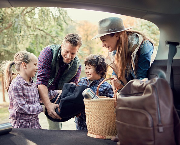 family-smiling family-smiling-getting-bags-out-of-car