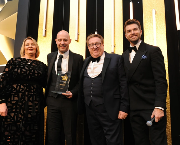 Fleet News 2025 Team Photo sg-fleet-team-with-fleet-news-hosts-accepting-award-on-stage