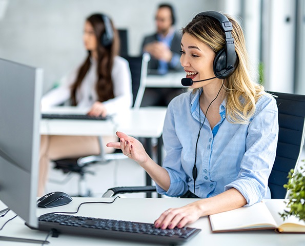 Helpdesk-operators-in-office-customer-service Helpdesk-operators-in-office-providing-customer-service-on-a-call