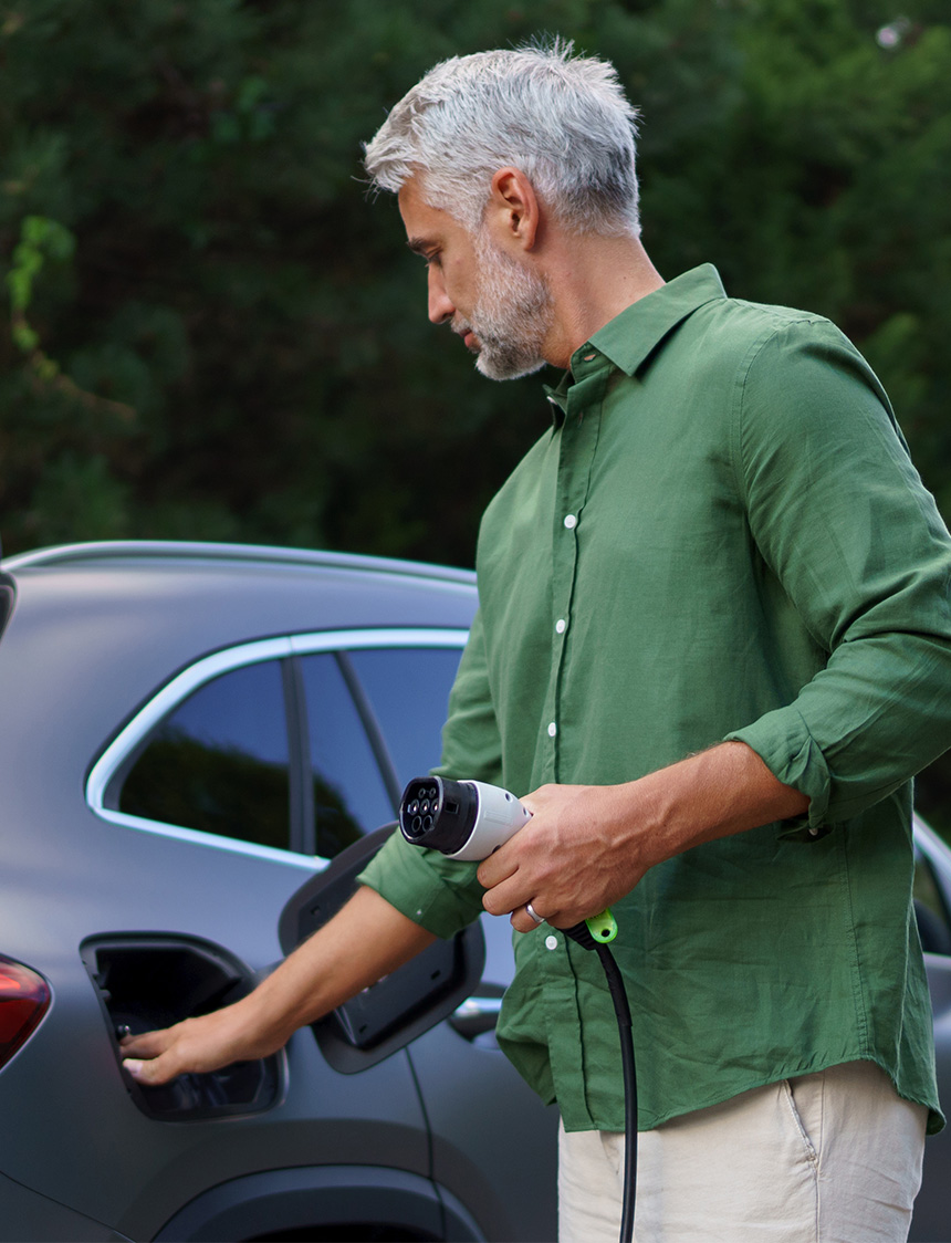 man-holding-electric-vehicle-charging-cable-close-up