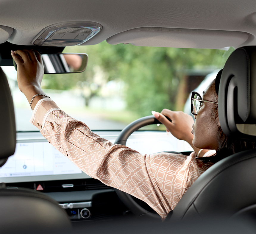 woman-checking-wing-mirror-in-car