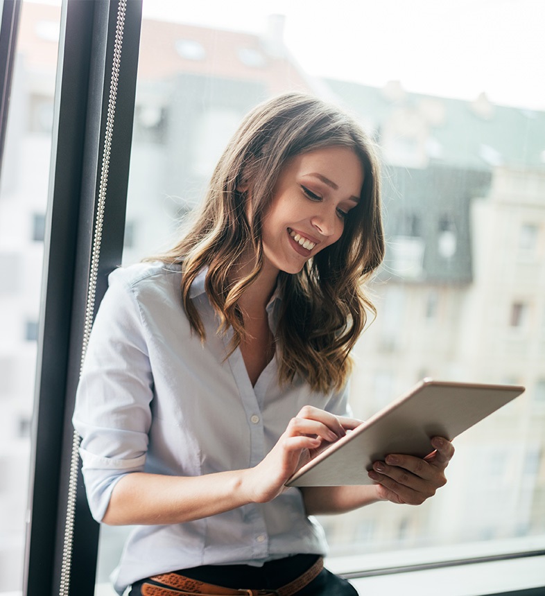 woman-smiling-at-tablet-device