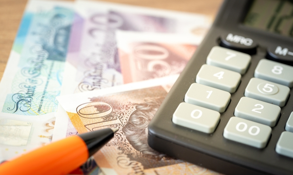 A calculator and money represent the increased costs of the Autumn budget.