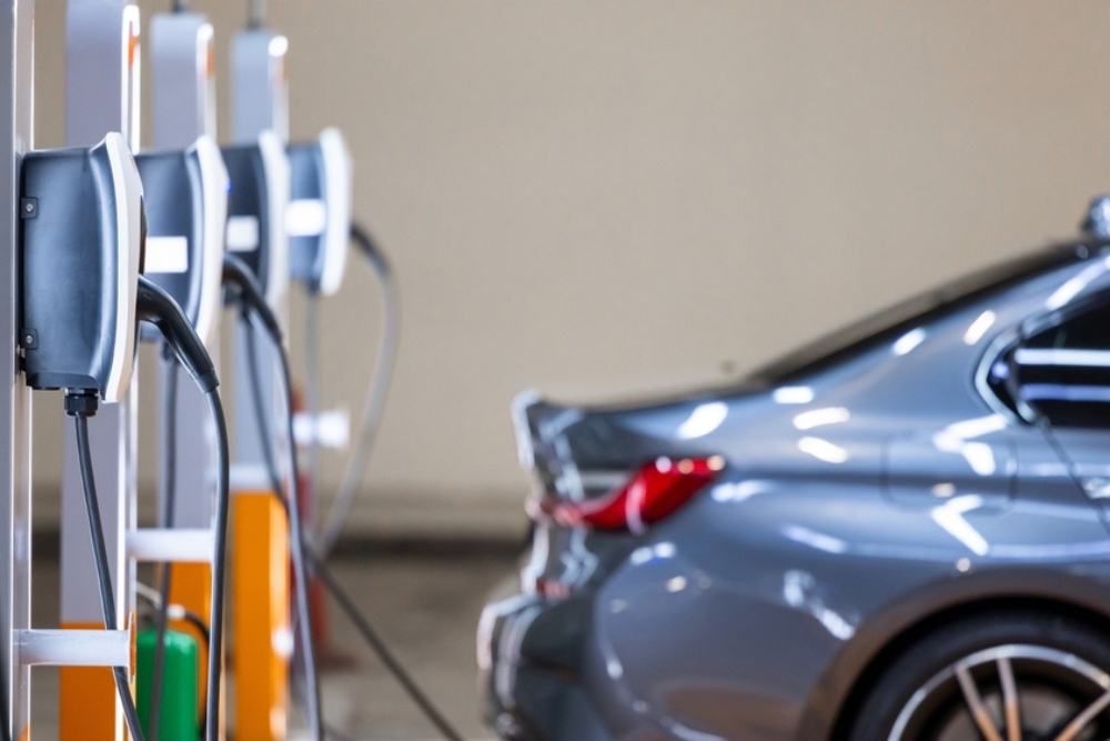 EV Fleet transition, multiple EV charge points lined up with a parked electric car, illustrating an EV fleet transition in progress
