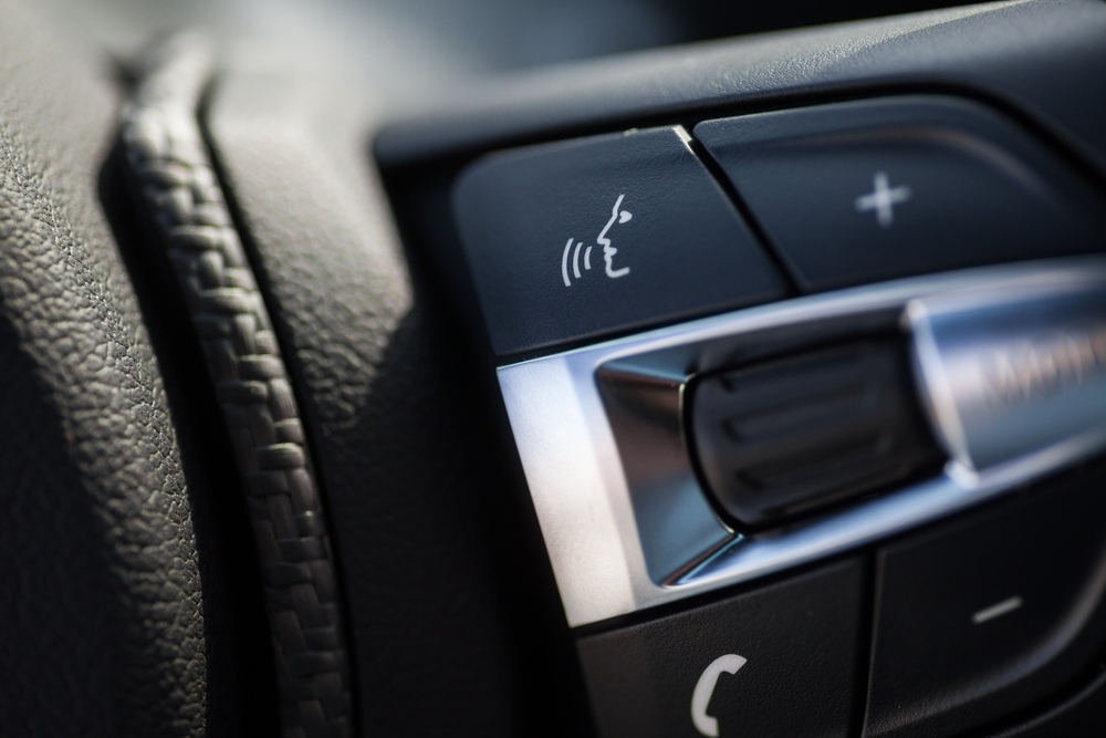 the 'voice activation' button on a non-descript car steering wheel