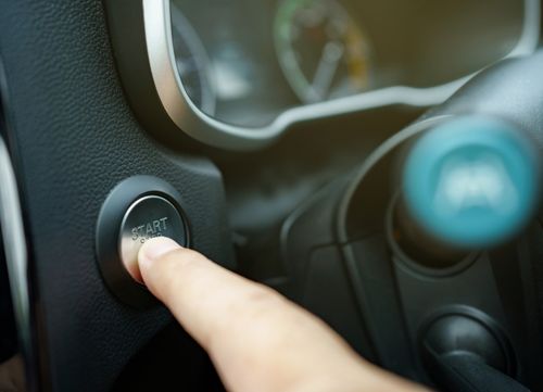 Person pressing keyless start button