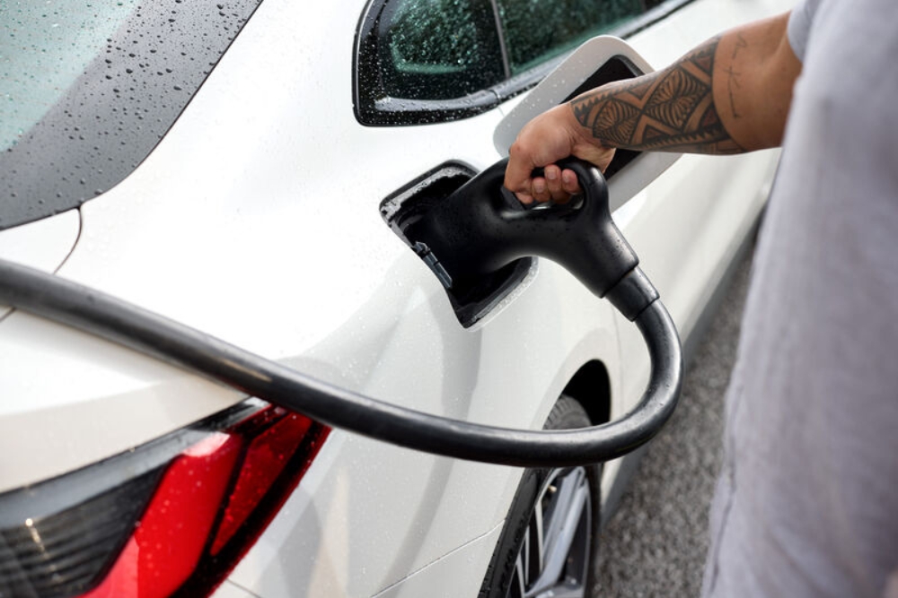 a man charging an EV or PHEV