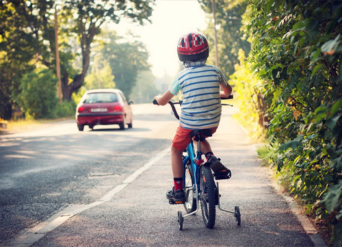 Child riding bike on the pavement