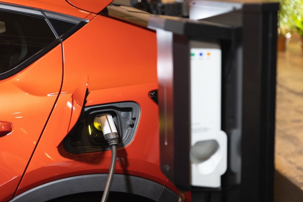 used-ev-leasing-featured-image image of orange electric car being charged