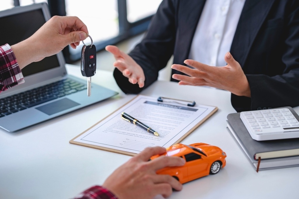 man holding toy car and car keys