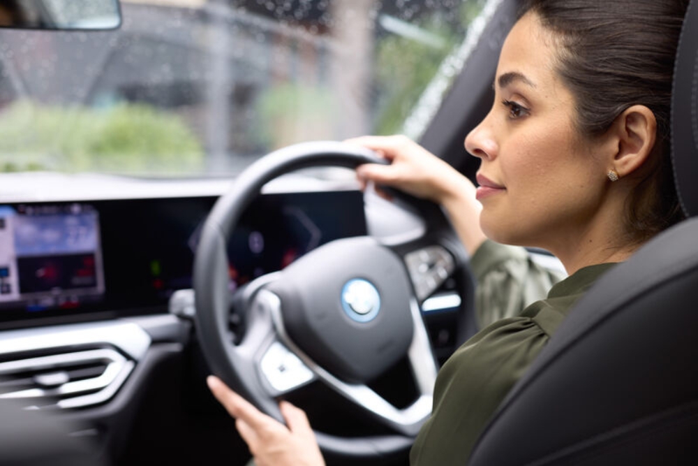 a woman driving an EV